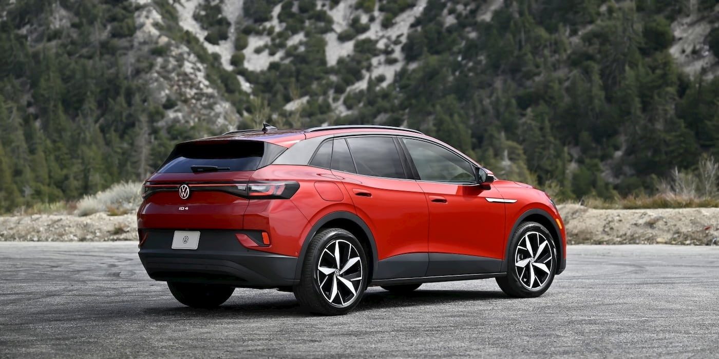Volkswagen ID.4 elektrikli SUV bir şarj istasyonunda park halinde, arka planda bulutlu gökyüzü