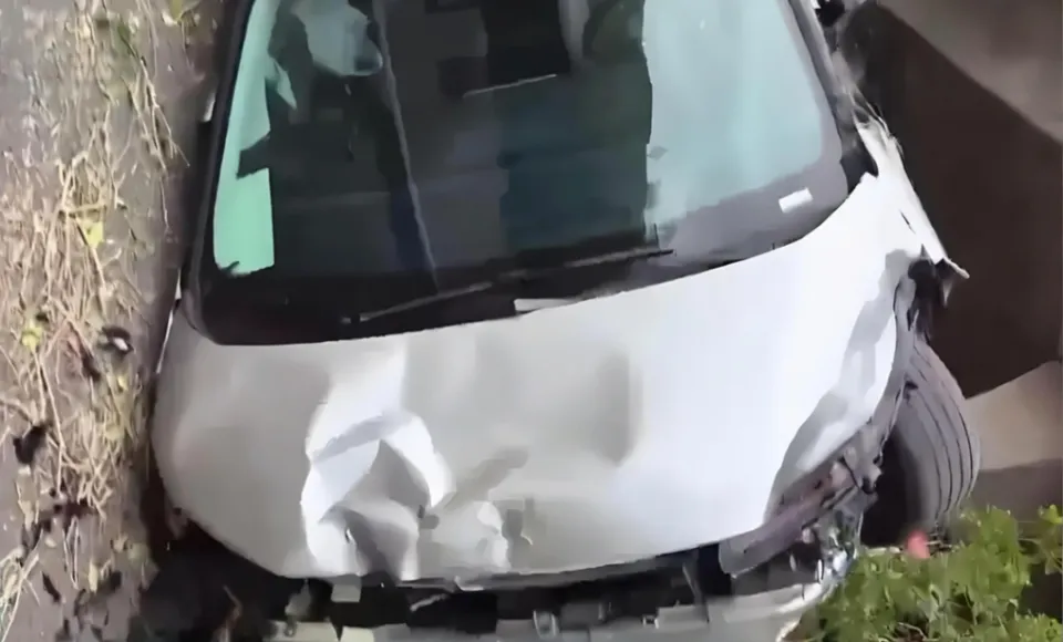 Kaza sonrası ön kısmı ağır hasar gören beyaz elektrikli MPV